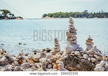 Spirituality And Wellness: Cairns On A Pebble Beach