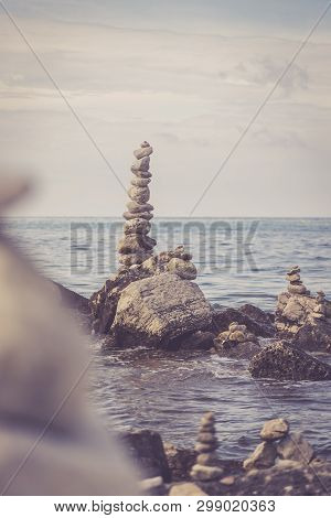 Spirituality And Wellness: Cairns On A Pebble Beach