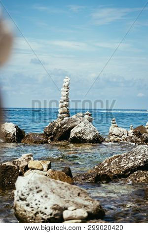 Spirituality And Wellness: Cairns On A Pebble Beach