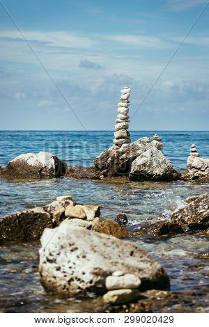 Spirituality And Wellness: Cairns On A Pebble Beach