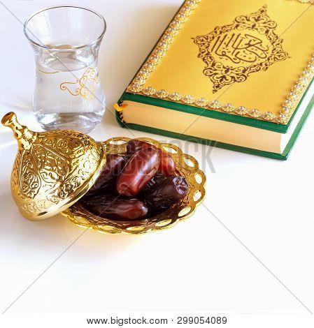 Organic Dried Dates Arabic Golden Plate, Cup Water And Quran Book. Iftar Holy Month Ramadan Concept.