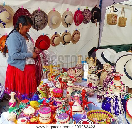 Cuenca, Ecuador-march 8, 2019: Woman Makes And Sells Souvenirs (baskets, Dolls, Bottles, Vases,) Mad
