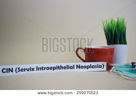 CIN (Servix Intraepithelial Neoplasia) text, grass pot, coffee cup, syringe, and face green mask. Healtcare/Medical and Business concept