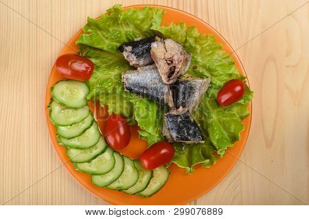 Pieces Of Sardine Iwashi On Lettuce Leaves With Red Tomatoes And Sliced Cucumbers.