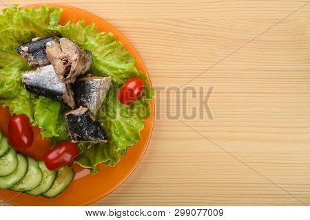 Pieces Of Sardine Iwashi On Lettuce Leaves With Red Tomatoes And Sliced Cucumbers.