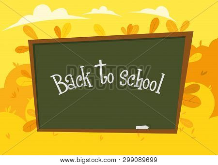 School Board With Chalk Inscription Back To School On The Background Of Autumn Yellow Foliage