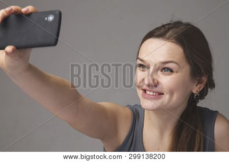 Portrait Of Pretty Happy Lovely Young Woman Making Selphie With Mobile Phone. Love And Positive Emot