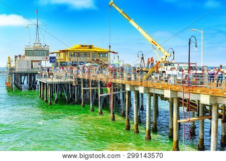 Famous Pier In Santa Monica With Tourists, A Suburb Of Los Angeles.