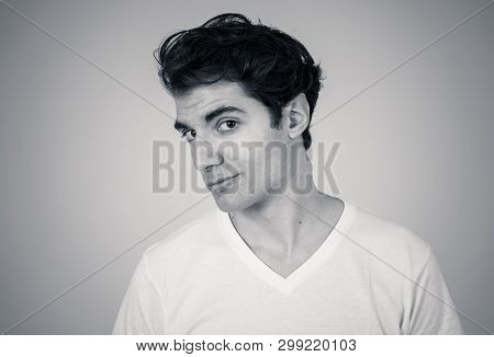 Black And White Portrait Of Young Sensitive Man Feeling In Love Looking Happy, Shy And Lucky. Isolat