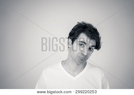 Black And White Portrait Of Young Sensitive Man Feeling In Love Looking Happy, Shy And Lucky. Isolat