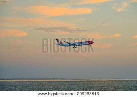 Airplane Flying Over The Sand Beach