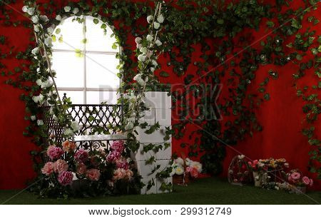 Photo Zone, Location With Garden Swings, Decorated With Flowers For The Wedding. Against A Bright Re