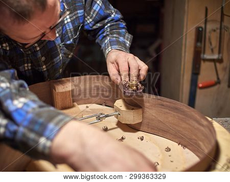 The Process Of Making A Classical Guitar. Giving The Sides Of The Guitar The Right Shape.