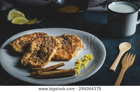 Spanish Typical Torrijas On White Plate With Lemon And Cinnamon.
