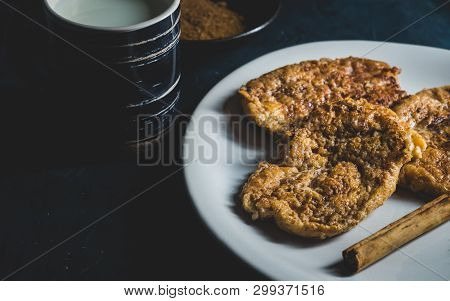 Spanish Typical Torrijas On White Plate With Lemon And Cinnamon.