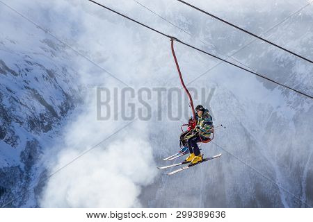 Dombai, Russia - January 3, 2014: People Are Lifting On Open Lft High Up In Caucasus Mountains