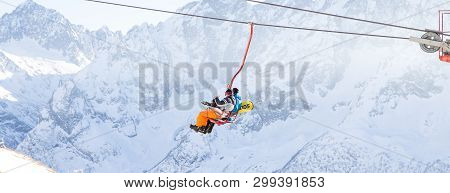Dombai, Russia - January 3, 2014: People Are Lifting On Open Lft High Up In Caucasus Mountains