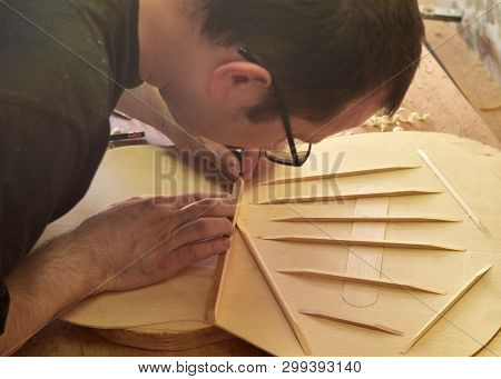 Lautner Makes A Classic Guitar. Luthier Gives A Chamfered Shape To The Brace.