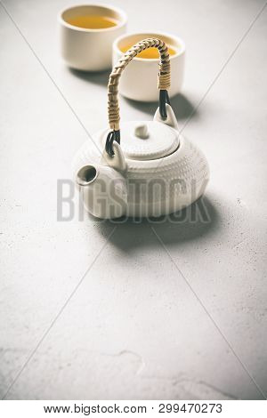 Ctramic Teapot And Cups On Concrete Background