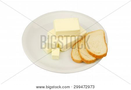 Butter And Slices Of Bread Are Lying On A Plate On A White Isolated Background