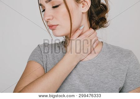 Close Up Picture Of Young Woman With Neckache Isolated.
