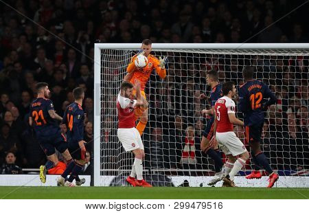 LONDON, ENGLAND - MAY 02 2019: Neto of Valencia drops a catch under a challenge from Shkodran Mustafi of Arsenal during the Europa League semi final leg one match between Arsenal and Valencia.