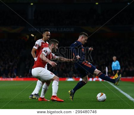 LONDON, ENGLAND - MAY 02 2019: Pierre-Emerick Aubameyang and Shkodran Mustafi of Arsenal defend during the Europa League semi final leg one match between Arsenal and Valencia.