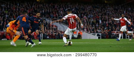 LONDON, ENGLAND - MAY 02 2019: Pierre-Emerick Aubameyang of Arsenal passes the ball for Alexandre Lacazette to score during the Europa League semi final leg one match between Arsenal and Valencia.