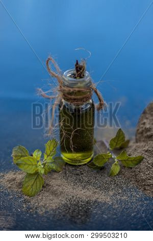 Ayurvedic Herb Brahmi Or Waterhyssop Oil In A Small Transparent Glass Bottle Along With Its Powder O