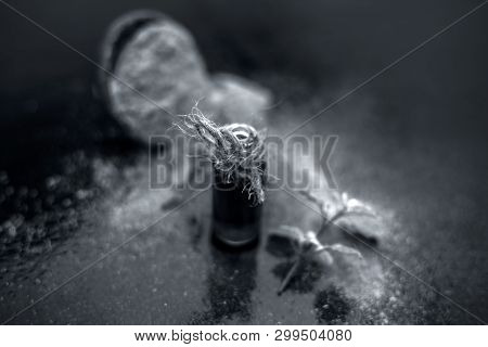 Ayurvedic Herb Brahmi Or Waterhyssop With Its Essence  In A Small Transparent Glass Bottle Along Wit