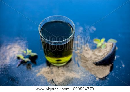 Ayurvedic Herb Brahmi Or Waterhyssop With Its Herbal And Beneficial Extract  In A Transparent Glass