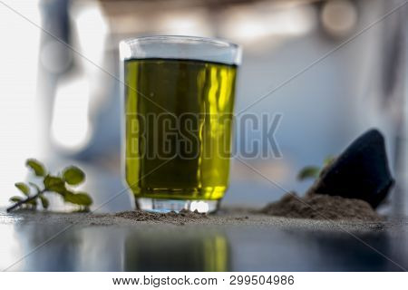 Ayurvedic Herb Brahmi Or Waterhyssop With Its Herbal And Beneficial Extract  In A Transparent Glass