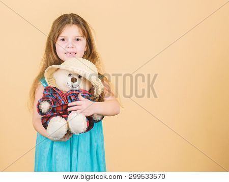 Cutest Ever. Kid Little Girl Carefully Hug Soft Toy Teddy Bear Beige Background. Tender Attachments.