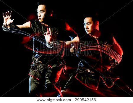 whushu chinese boxing kung fu Hung Gar fighter isolated man isolated on black background with speed light painting effect motion blur