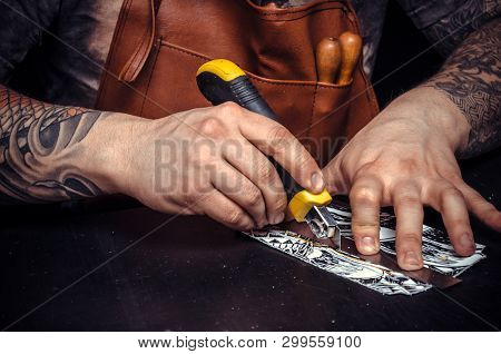 Leather Worker Cutting Out Leather Goods In A Workshop