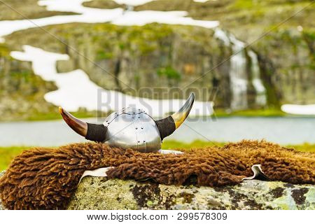 Viking Helmet On Lake Shore In Norway. Tourism And Traveling Concept