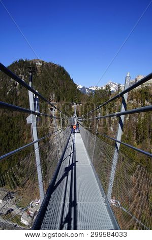 Reutte, Tyrol, Austria - April 20, 2019: Unknown And Unidentifiable Participants Walking On The Susp