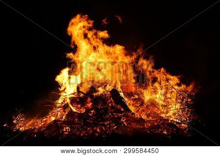 Large Bonfire, Burning And Glowing With Soft Flames, Sparkles Flying Agains The Dark Sky. Glowing Wo