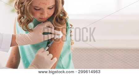 Vaccination Concept. Girl Receiving Measles Vaccine In Clinic, Copy Space