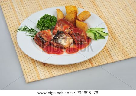 Plate With Sardines Tomatoes And Aromatic Herbs On Gray Isolated Background