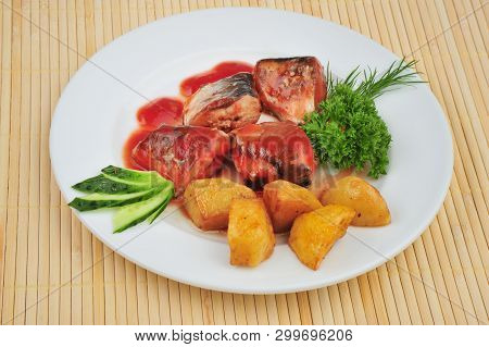 Plate With Sardines Tomatoes And Aromatic Herbs On A Table
