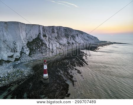 Aerial Drone Landscape Image Of Lighthouse And Chalk Cliffs At Sunrise In England
