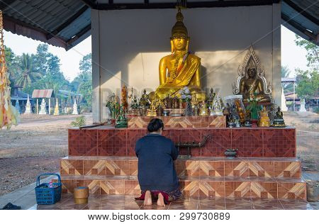 Faithful Buddhist Woman Prays In The Akat Amnuai Temple, Sakon Nakhon Province, Isan, Thailand