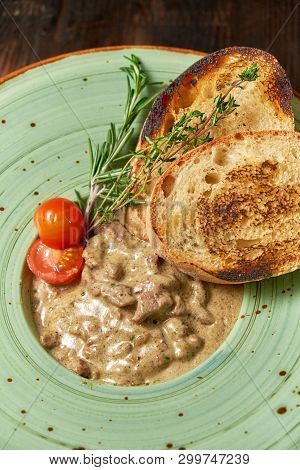 Beef Stroganoff With Croutons. Dark Wooden Background. Restaurant Menu