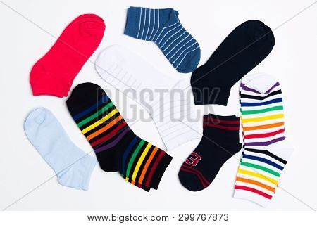 Many Various Colorful Textile Socks For Warm Weather. Legs Clothes On White Background. Flat Lay Sty