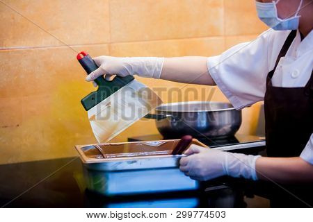 Cook Woman Is Mixing Chocolate Cream With Professional Spatula In The Chocolate Shop. Elted Dark Cho