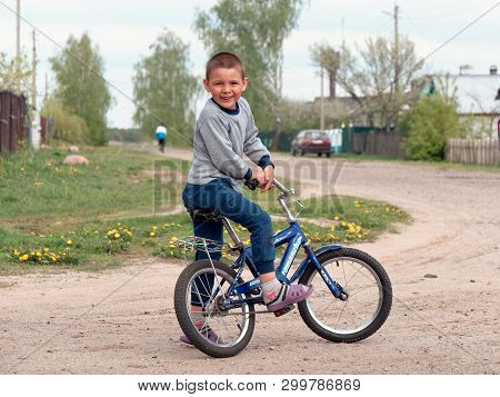 Gomel, Belarus - May 4, 2019: Children Ride A Bike In The Village Of Derbichi.