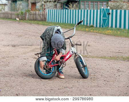 Gomel, Belarus - May 4, 2019: Children Ride A Bike In The Village Of Derbichi.