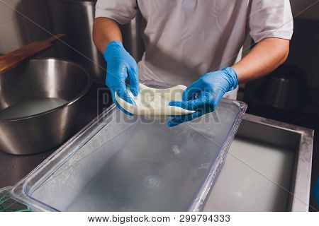Artisan Cheesemaker Cuts The Mozzarella With Hands.