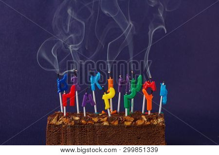 Happy Birthday Brownie Cake With Peanuts, Salted Caramel And Colorful Unlighted Smoking Candles On T